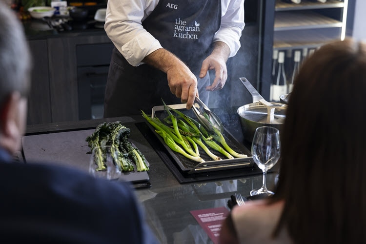 Cooking chargrilled zucchini, kale and spring onion salad.